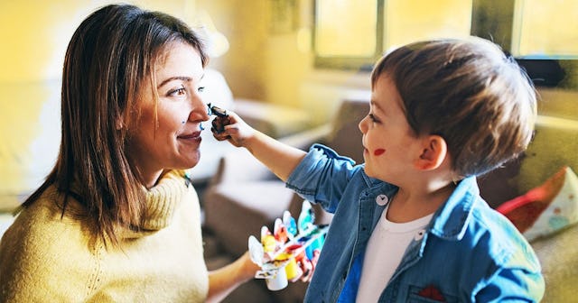 Mother and son having fun with finger paint