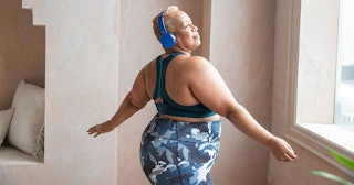 woman dancing with headphones on