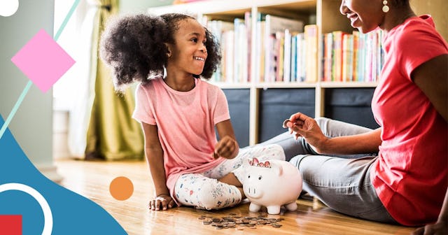 mother and daughter putting money in piggybank