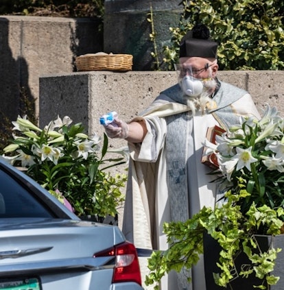 This Priest Is Going Viral For Shooting Holy Water With A Squirt Gun During Socially Distanced Servi...