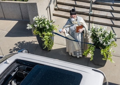 This Priest Is Going Viral For Shooting Holy Water With A Squirt Gun During Socially Distanced Servi...