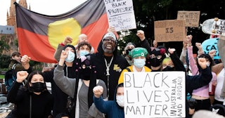 Protesters shout slogans and hold up signs in Hyde Park during a 'Black Lives Matter' rally on 02 Ju...