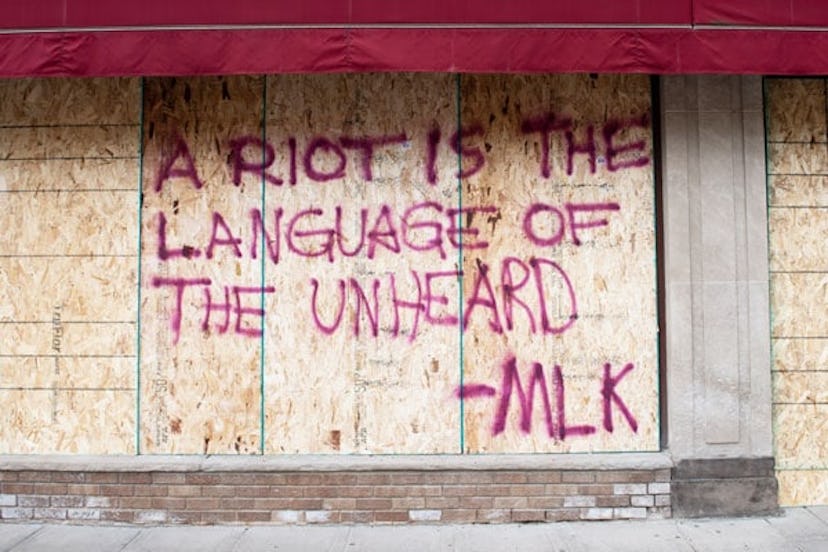 A Martin Luther King Jr. quote is seen on Lake Street during the fourth day of protests over the dea...