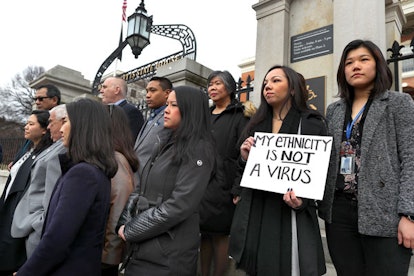 Members of the Asian American Commission hold a press conference on the steps of the Massachusetts S...