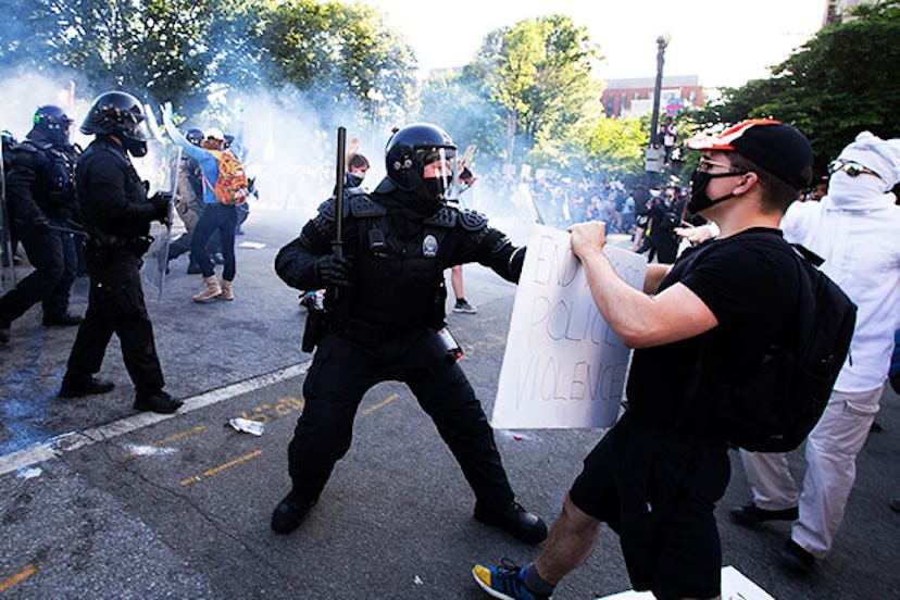 Police officers clash with protestors near the White House on June 1, 2020 as demonstrations against...