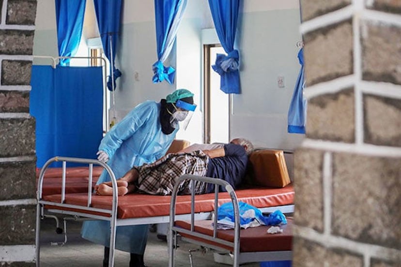 A Yemeni doctor in full hazmat suit treats a COVID-19 patient at a quarantine center in Yemen's thir...