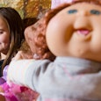 A girl plays with a "Cabbage Patch Kid" doll at the 2012 "Dream Toys" exhibition in central London o...