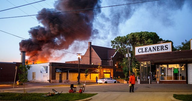 Flames rise from the cleaners shoop near the Third Police Precinct on May 28, 2020 in Minneapolis, M...