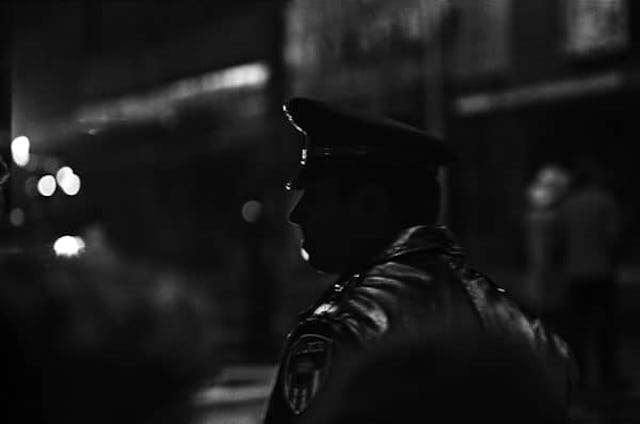Police With No Identifying Badges Spark Calls for Reform: Policeman on Street at Night