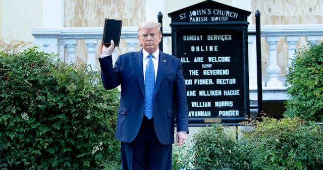 US President Donald Trump holds a Bible while visiting St. John's Church across from the White House...