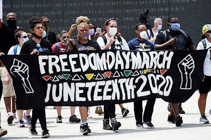 Demonstrators arrive at the Martin Luther King, Jr. Memorial during a Juneteenth march in Washington...