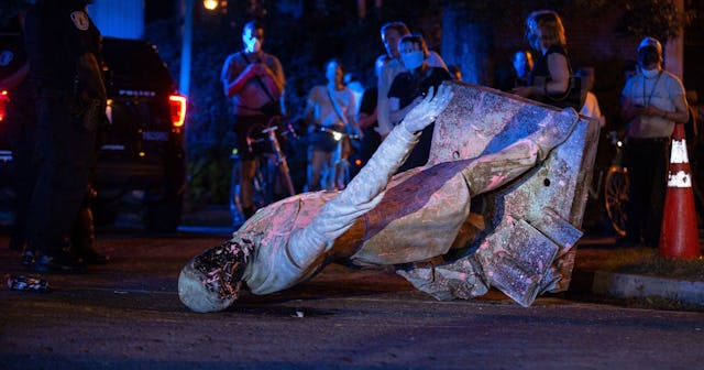 A statue of Confederate States President Jefferson Davis lies on the street after protesters pulled ...