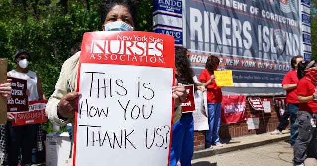 Healthcare workers hold signs during a nurse protest at Rikers Island Prison over conditions and cor...