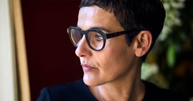 Portrait of serious short-haired woman wearing glasses looking away