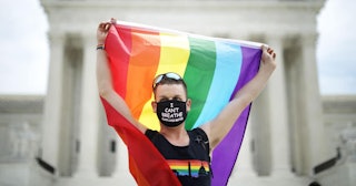 Joseph Fons holding a Pride Flag, stands in front of the U.S. Supreme Court building after the court...