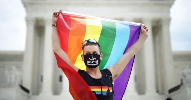 Joseph Fons holding a Pride Flag, stands in front of the U.S. Supreme Court building after the court...