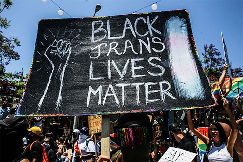 A protester holds a placard saying 'Black Trans Lives Matter' during the march.