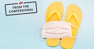 Still life of a white face mask and orange flip-flops on blue background, on vacation with a protect...