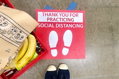 social distancing sign on the floor at a store