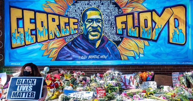 Flowers, signs and balloons are left near a makeshift memorial to George Floyd near the spot where h...