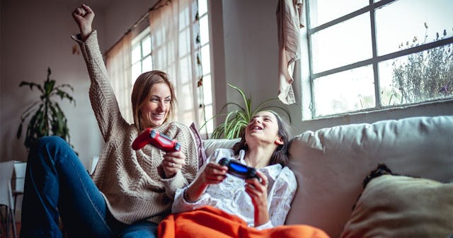 Mother and daughter playing video games