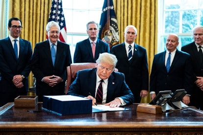 U.S. President Donald Trump signs H.R. 748, the CARES Act in the Oval Office of the White House on M...