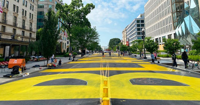 Protester paint a giant Black Lives Matter sign on 16th street near the White House (C, rear) in Was...