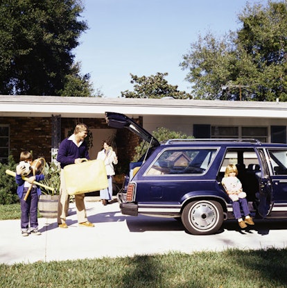 Family going on vacation loading station wagon