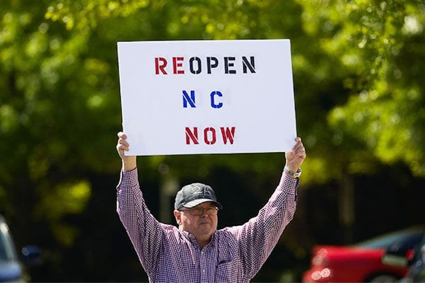 Protesters from a grassroots organization called REOPEN NC protests the North Carolina coronavirus l...
