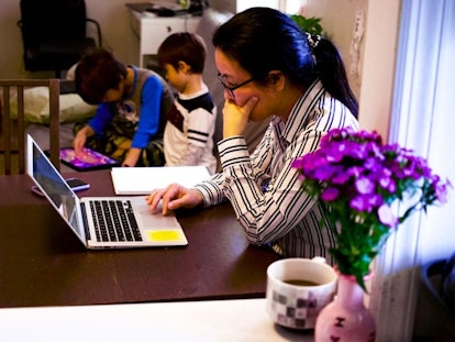 The Working Mom's Plight: Mother working remotely with children in the background