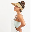 A woman wearing a beige visor, and three perfect visors to protect the precious face from the sun