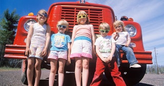 hildren wearing sunglasses with a fire truck