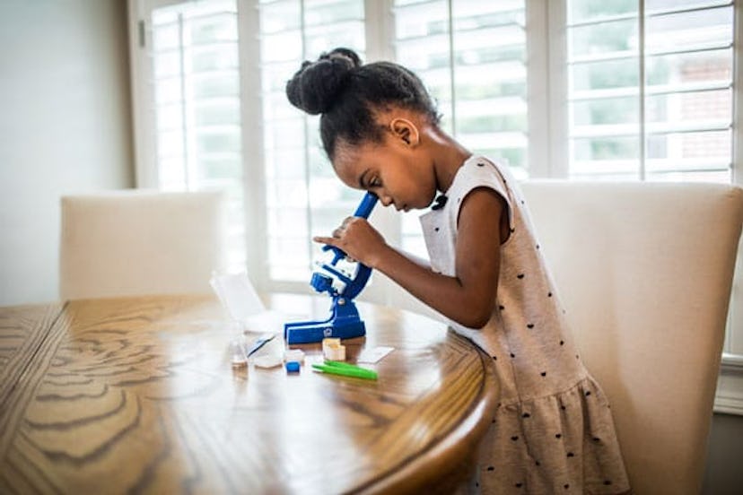Young girl looking in microscope
