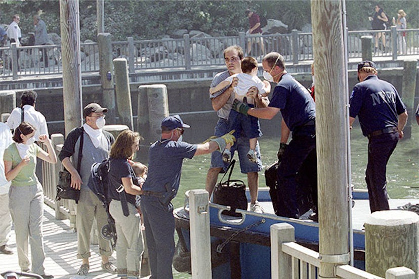 Civilians are evacuated by boat near the site of the collapse of the World Trade Center on September...
