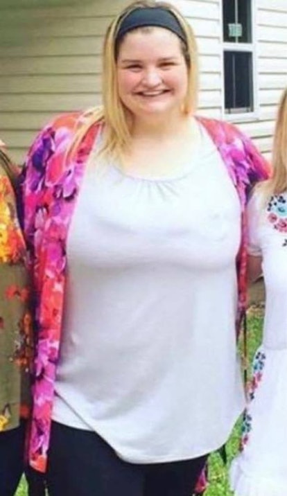 Allison LaCombe with blonde hair, wearing a pink floral blouse and a white shirt