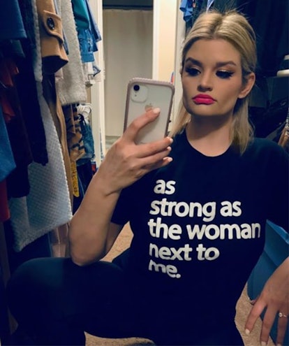Allison LaCombe in the closet wearing a black shirt with "as strong as the woman next to me" text on...
