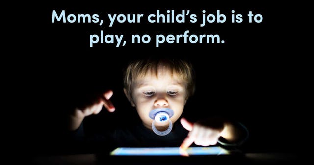 1 year old boy looking a digital tablet in the dark