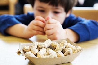 Little boy eating peanuts