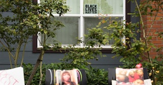 A Black Lives Matter sign sits in a window behind a memorial for Charleena Lyles at the apartment bu...