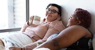 Marriage Shows You Who You Really Are: lesbian couple talking in bed