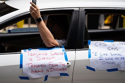 Chicago Teachers Union members and supporters join a car caravan outside Chicago Public Schools (CPS...