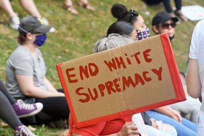 eading, PA - July 8: A protester holds a sign that reads "End White Supremacy" during the March Agai...