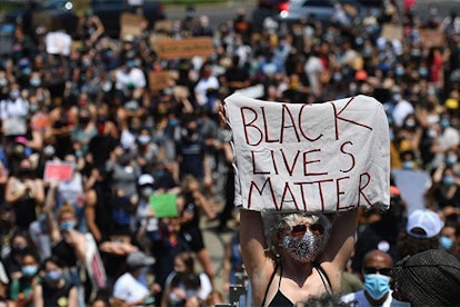 A protestor holds a "Black Lives Matter" sign during a Juneteenth rally on June 19, 2020 in front of...