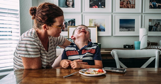 mom holding boy while he is crying