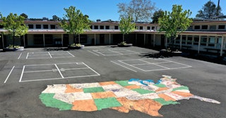 A cmap of the United States is painted on the playground at Kent Middle School on April 01, 2020 in ...