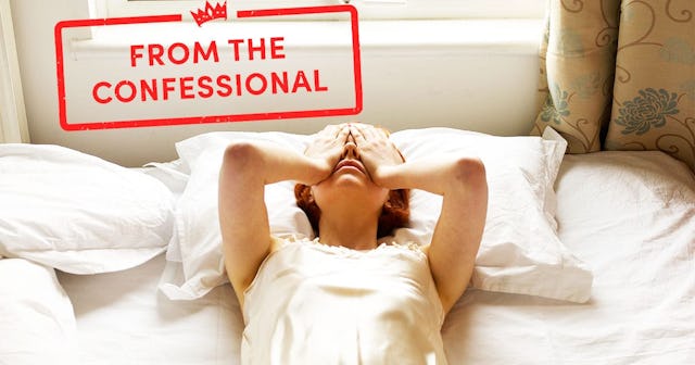 woman on bed with hands over eyes