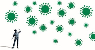 Woman shielding eyes by large green coronavirus