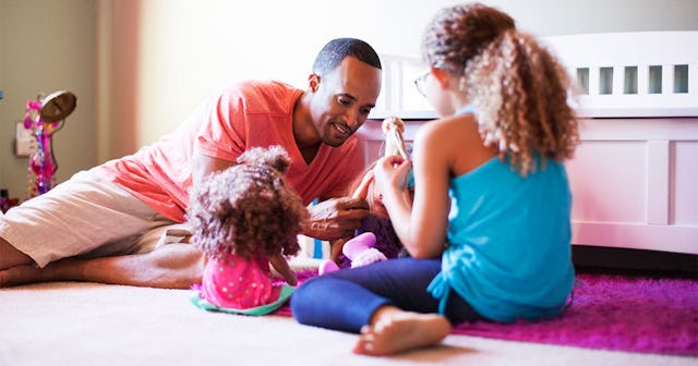 Father and daughter playing together with dolls at home