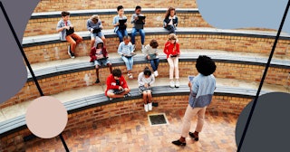 School children & teacher having class outside with digital tablets