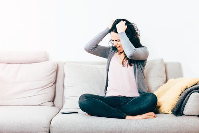 My Faith In Americans Has Reached Its Low Point: Frustrated Woman With Hand In Hair Sitting On Sofa ...